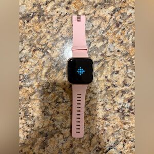 Rose gold Fitbit Versa smart watch